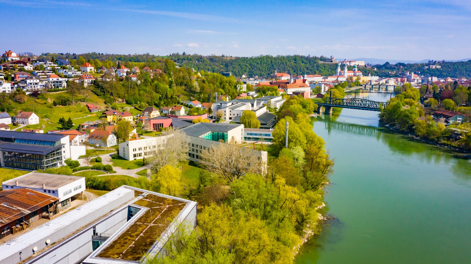 A photo of the university of Passau's campus with the river Inn on the right
